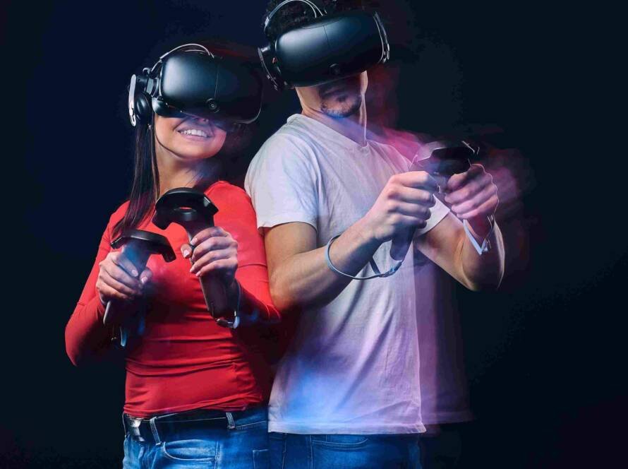 happy-friends-playing-video-games-wearing-virtual-reality-glasses-with-controllers-isolated-dark-background-photo-with-light-effect_11zon(1)